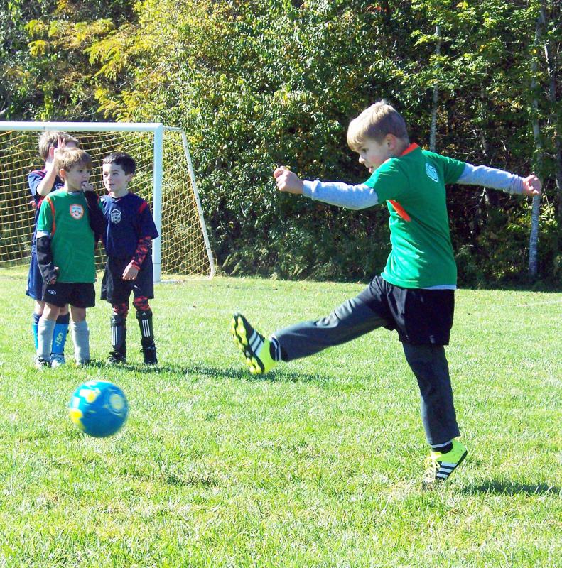 With a swift kick, Brendan Fuller of Marion launches a soccer ball down the field. BY MATTHEW BERNAT